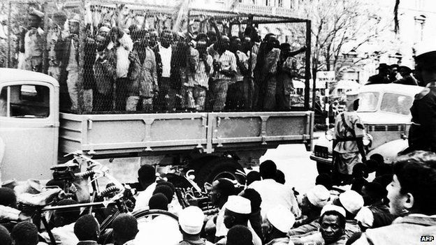 Some of the hundreds of Mau Mau suspects who were rounded up in Nairobi, Kenya, on 21 October 1952, are taken away for interrogation in a police "cage".