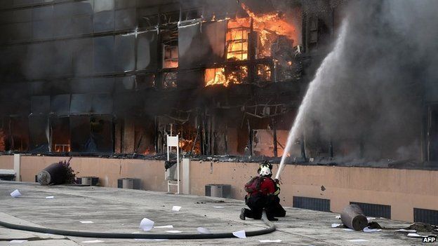 Firefighters attempt to extinguish a fire at the Guerrero state capital building in Chilpancingo, Mexico - 13 October 2014