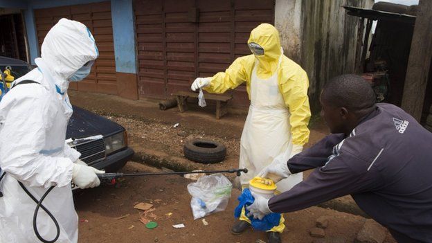 Health workers in protective equipment near Rokupa Hospital, Freetown on 6 October 2014.