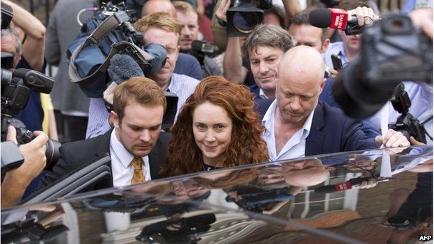 Former Head of News International Rebekah Brooks (C) and her husband Charlie Brooks leave after giving a statement to members of the media in the wake of the phone-hacking trial, in London on 26 June 2014
