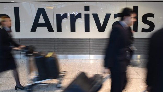 Passengers arrive at London's Heathrow airport on 14 October 2014.