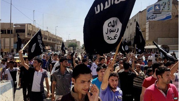 People in Mosul at a pro-IS demonstration in June 2014