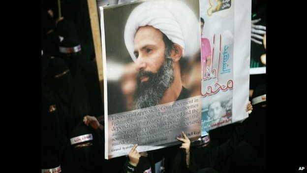 Shia women protesters hold a poster of Sheikh Nimr Baqir al-Nimr at the funeral of three people killed at a demonstration following his arrest (30 September 2012)