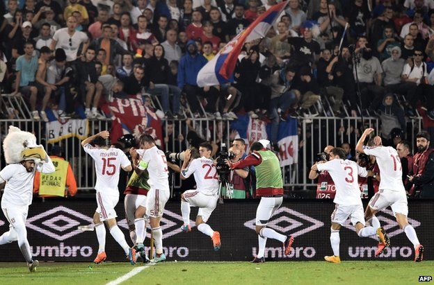 Albania players leave the field at the stadium in Belgrade, 14 October