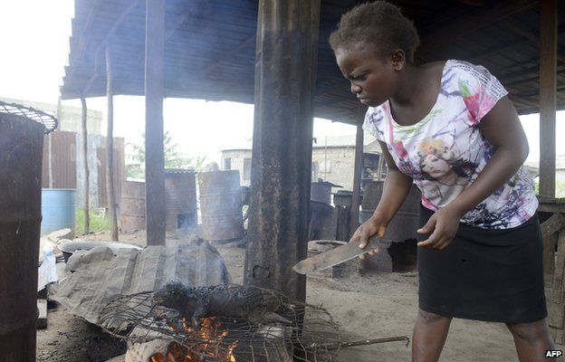 woman roasts bushmeat