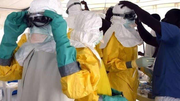 Medical staff adjust their protection suits in Monrovia, Liberia on 27 September 2014