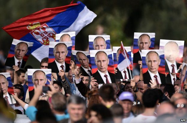 Serbian nationalists wave posters of Vladimir Putin in Belgrade, 16 October