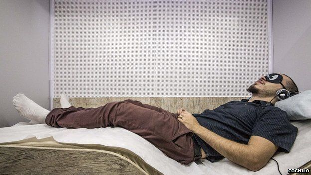A man in Sao Paulo having a sleep at a branch of Cochilo