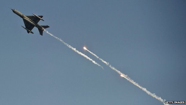 An Indian Air Force MiG-21 aircraft fires flares on the outskirts of Delhi on 8 October 8, 2012