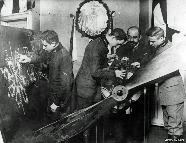 German pilots receive instruction on the mechanism of an aeroplane