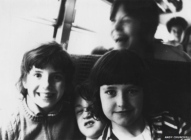 Kids smiling on bus