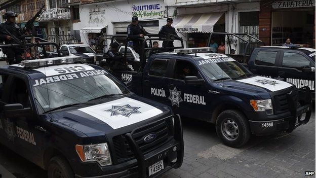 Members of the Mexican Federal Police are seen in a street of Teloloapan on 19 October, 2014.