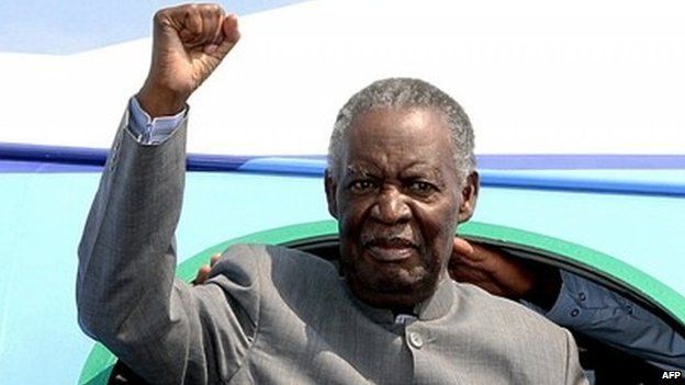 Zambian President Michael Sata gestures upon arrival at Solwezi airport before addressing supporters at an election campaign meeting on 10 September 2014