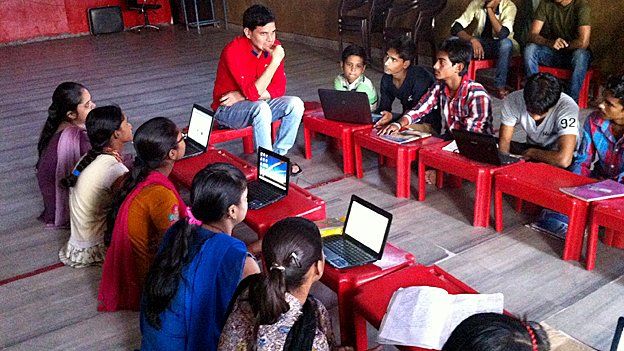 Children learning how to use the internet in Delhi