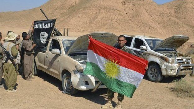 Peshmerga fighters with captured IS vehicles near Tikrit, Iraq - 8 October