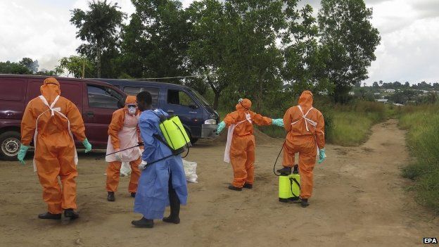 Sierra Leone's Red Cross employees are disinfected near Freetown. Photo: 20 October 2014