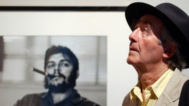 Swiss photographer Rene Burri poses in front of his most famous photo of Che Guevara in Lausanne, Switzerland on 24 June 2004