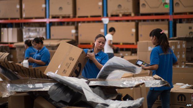 Chinese workers packing goods at a warehouse in the Shanghai Pilot Free Trade zone