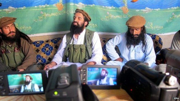 A picture made available on 15 October 2014 shows Shahidullah Shahid (C), the former spokesman of Pakistani Taliban speaking to journalists at an undisclosed location near the Pak-Afghan border, 21 February 2014.