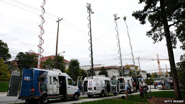 Television satellite vans park outside Emory University Hospital in Atlanta, Georgia.