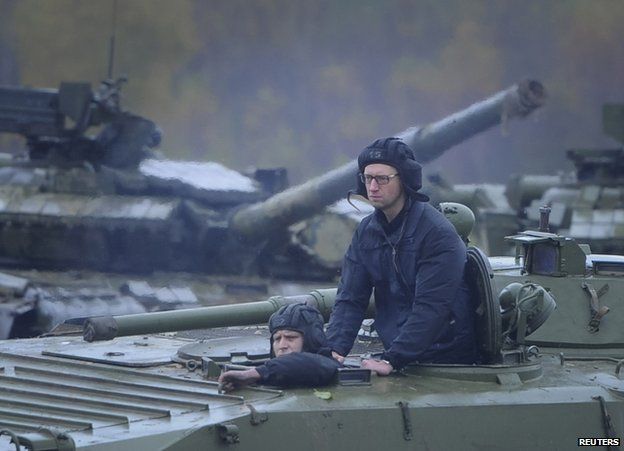 Ukrainian Prime Minister Arseniy Yatseniuk on an armoured personnel carrier near Lviv, 21 October