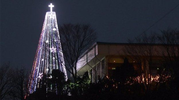 This Tuesday, 21 Dec 2010 photo shows a giant steel Christmas tree lit up at the western mountain peak known as Aegibong in Gimpo, South Korea