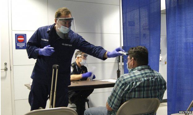 A passenger arriving from Sierra Leone is screened at O'Hare International Airport in Chicago on 16 October 2014.