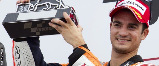 Repsol Honda Team's Spanish rider Dani Pedrosa celebrates second place after the Valencia Moto Grand Prix at Ricardo Tormo racetrack in Cheste near Valencia on November 10, 2013.