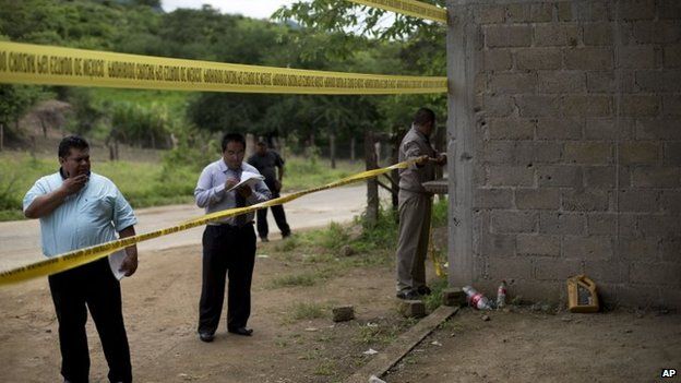 State authorities use crime scene tape to seal off an unfinished warehouse where 22 people were killed on 30 June 2014 (Photo from 3 July 2014)