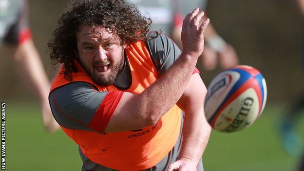 Adam Jones passes the ball during a training session