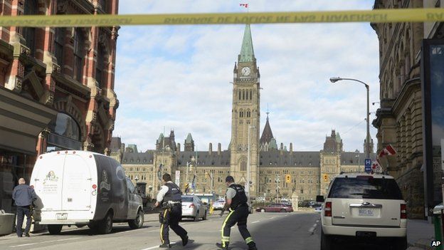 Police secure the scene of a shooting on Parliament Hill in Ottawa
