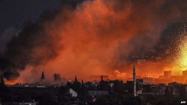Smoke and flames rise following an explosion in the Syrian town of Kobane (20 October 2014)