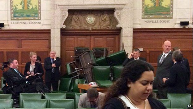 In this photo provided by Conservative MP Nina Grewal, MPs barricade themselves in a meeting room on Parliament Hill in Ottawa, October 22