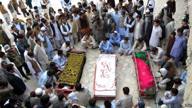 Relatives attend the funeral ceremony of the victims of an attack on a bus in Quetta