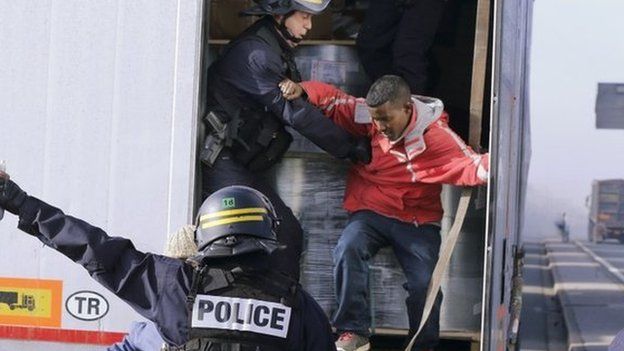 French riot policemen force out migrants in Calais, France on 22 October 2014