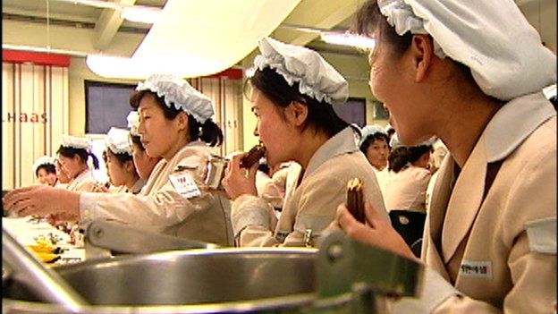 Still of North Koreans eating Choco Pie