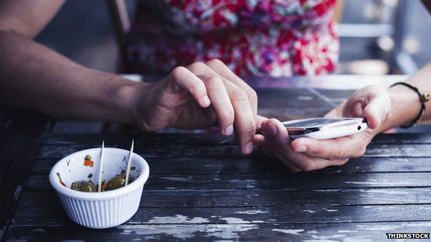 Women on mobile in cafe