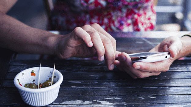 Women on mobile in cafe