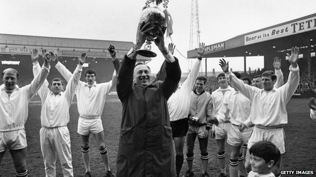 Manchester City Manager, Joe Mercer holds the League Championship trophy aloft after an exhibition match against Bury at Maine Road, Manchester in 1968