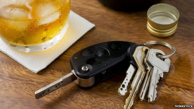 Car keys by a drink