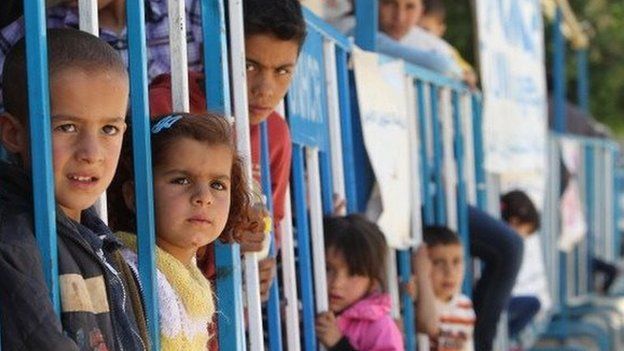 Syrian refugee children wait to be registered at a refugee camp in Bar Elias, in the Lebanese Bekaa valley on 30 May 2014
