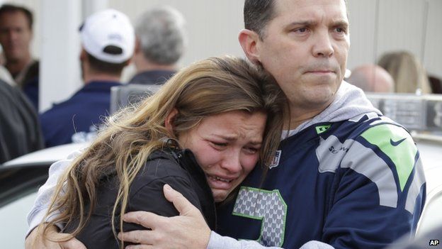 People embraced in Marysville, Washington, on 24 October 2014