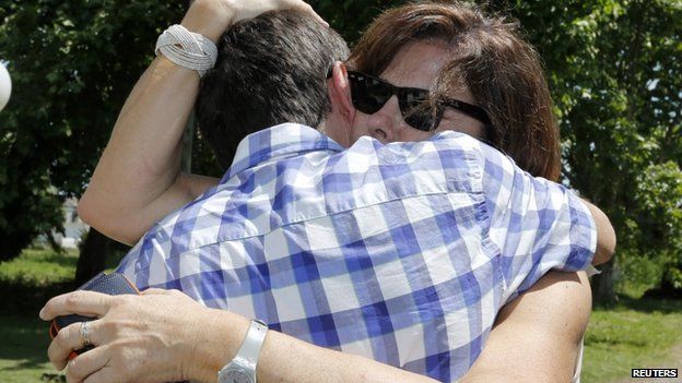 Patricia Perez Catan is embraced by her brother Fernando as they visit the former notorious clandestine detention centre known as La Cacha during Argentina's last dictatorship, in La Plata on 24 October 2014