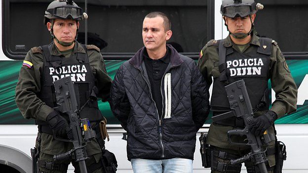 Colombian policemen guard the FARC member Alexander Herrera aka Rodrigo Pirinolo, before his extraditation to the United States in Bogota on 9 March 2012.