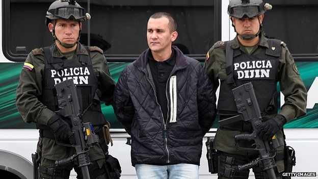 Colombian policemen guard the FARC member Alexander Herrera before his extradition to the United States in Bogota on 9 March 2012.