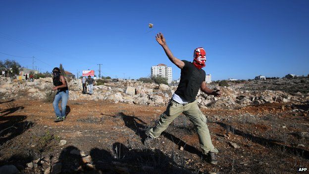 Palestinian demonstrators throwing stones at Israeli police 24 October in Silwad Ramallah
