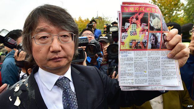 South Korean activist Choi Woo-Won, the main organiser for the balloon launch event, shows an anti-North Korea leaflet after they were blocked by local residents near Imjingak peace park in the border city of Paju, north of Seoul, on October 25,