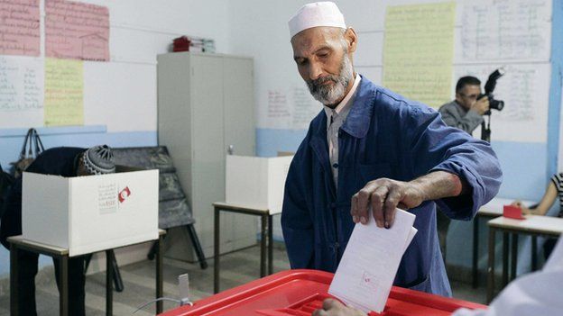 A man casts his vote at a polling station in Tunis October 26, 2014