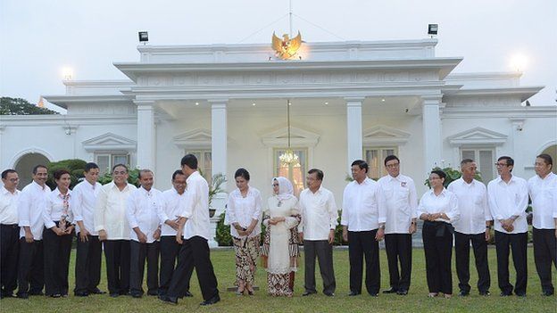 Indonesian President Joko Widodo shakes hands with his ministers