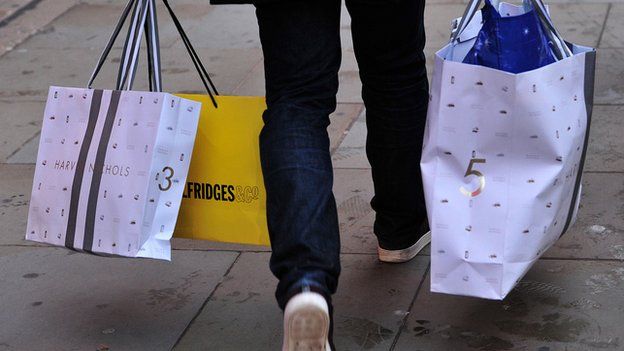 A shopper carries bags